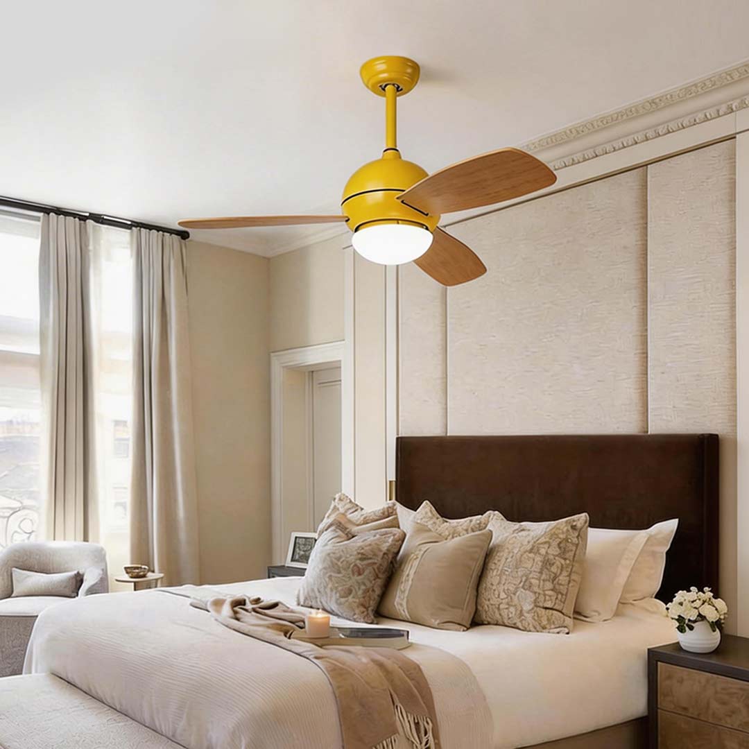 Wooden blade ceiling fan with light providing ambient light in a stylish bedroom.