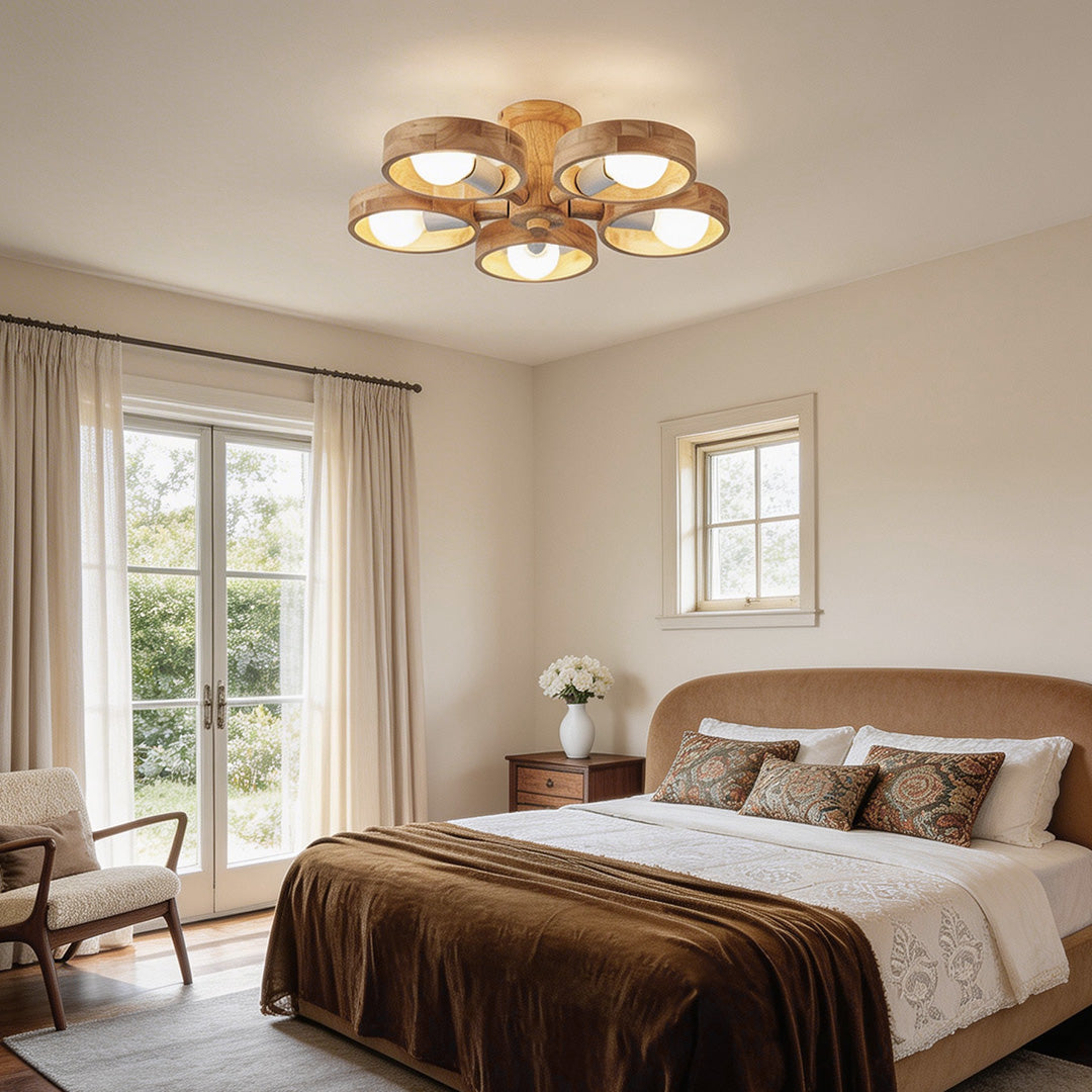 Wooden chandeliers with a modern design, illuminating a cozy bedroom with natural light.