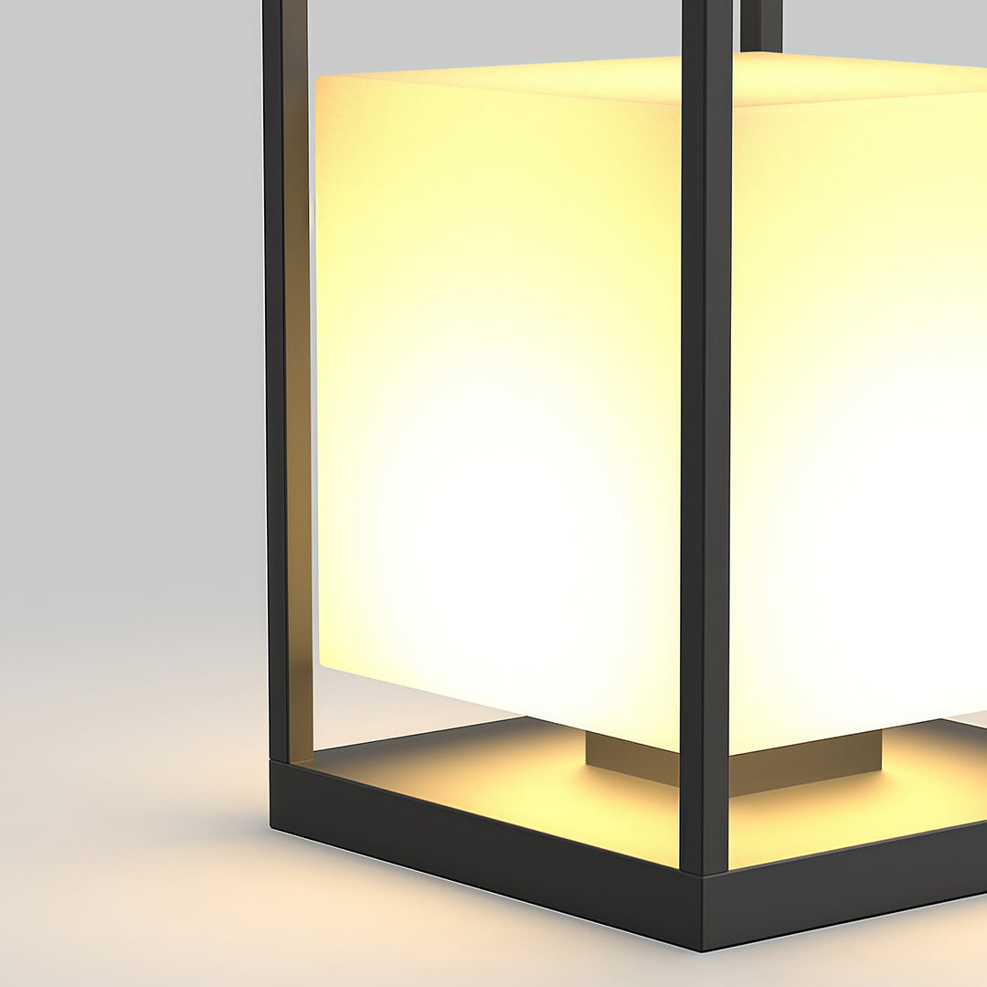 Contemporary outdoor lantern with a black metal frame, placed on a wooden deck for stylish outdoor lighting.