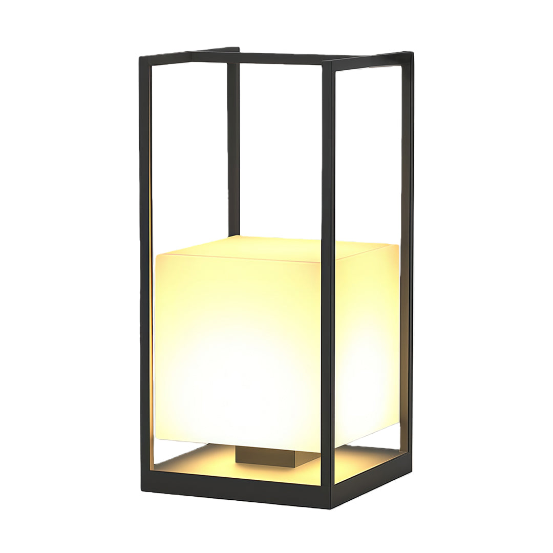 Contemporary outdoor lantern with a black metal frame, placed on a wooden deck for stylish outdoor lighting.