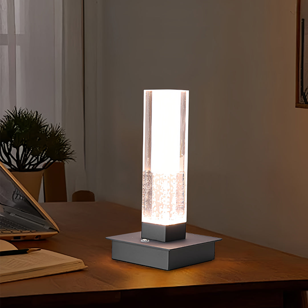 Elegant small black pendant light on wooden desk providing sophisticated task lighting atmosphere