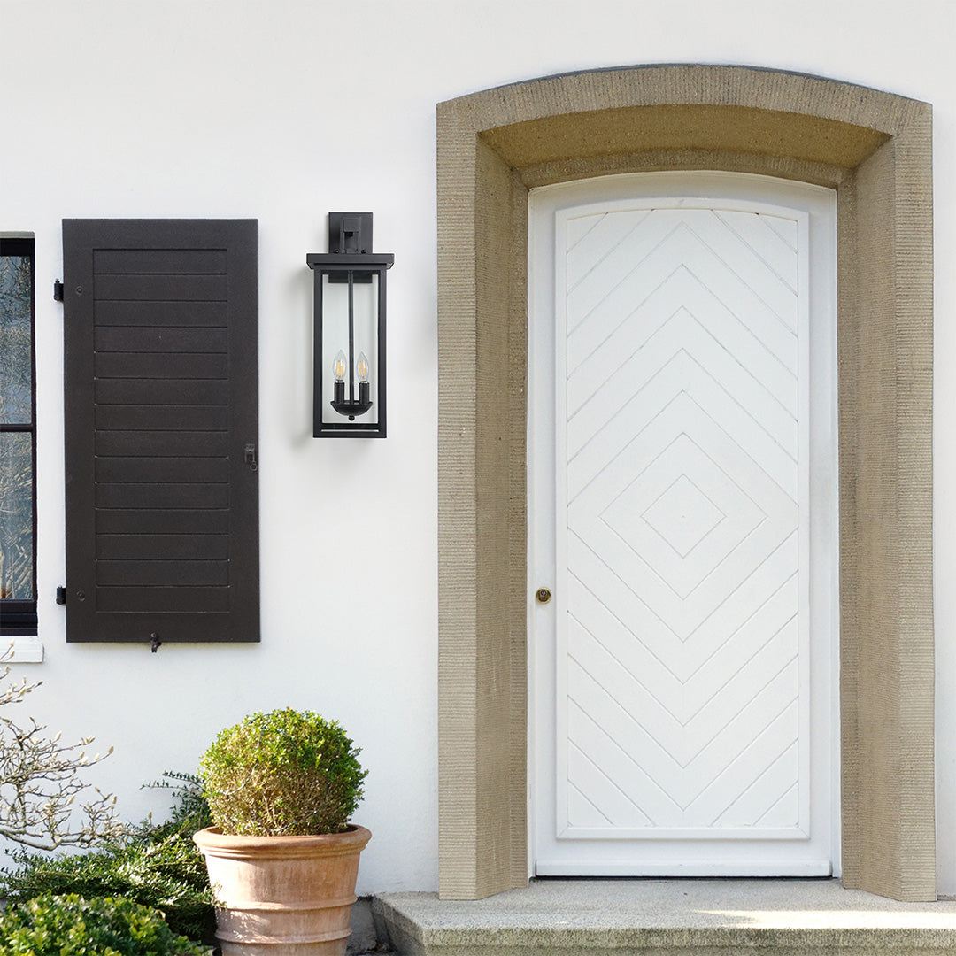 Black external wall light installed above a wooden door, adding a stylish touch to the entryway.
