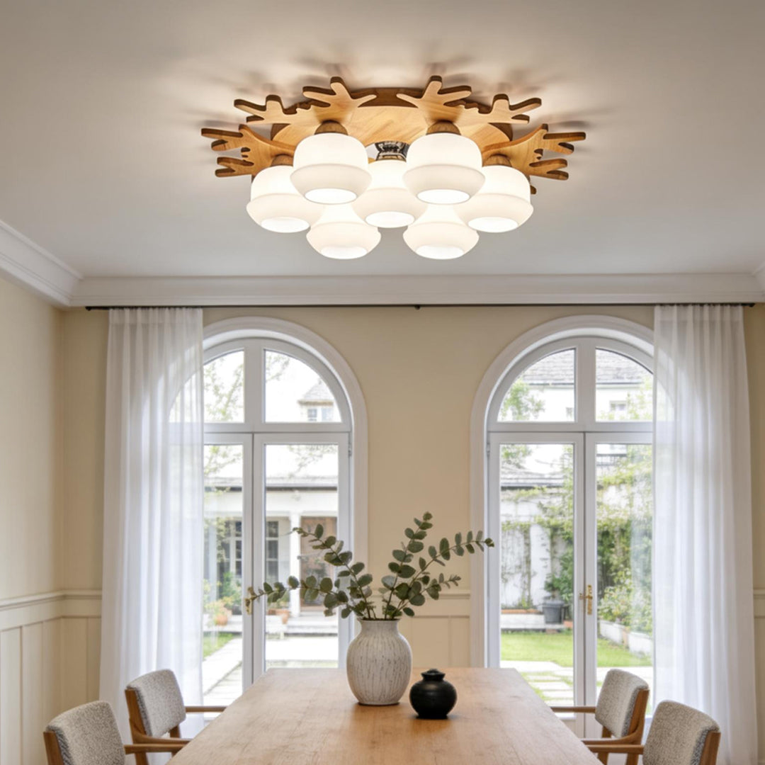 Modern wooden flush mount globe ceiling lamp with multiple frosted glass globes in a bright dining room interior.