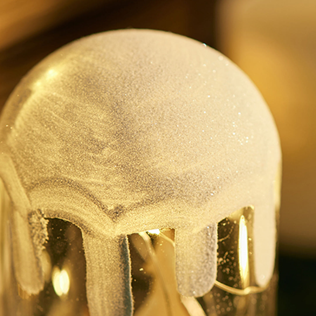 Two glowing woodland dome lights set among candles, styled like illuminated white glass table lamp decor.