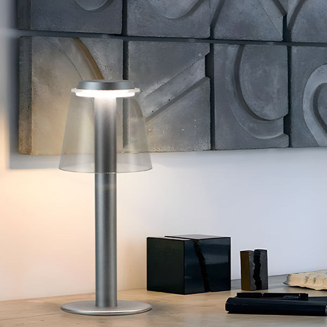 Contemporary workspace featuring adjustable table lamp providing focused illumination for reading and work