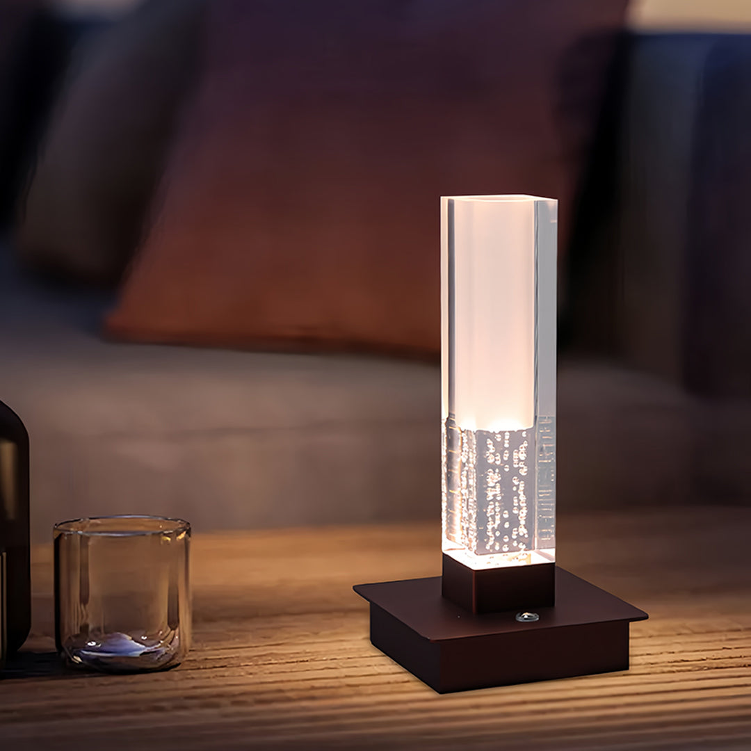 Modern workspace featuring small black pendant light with geometric square base and crystal accents