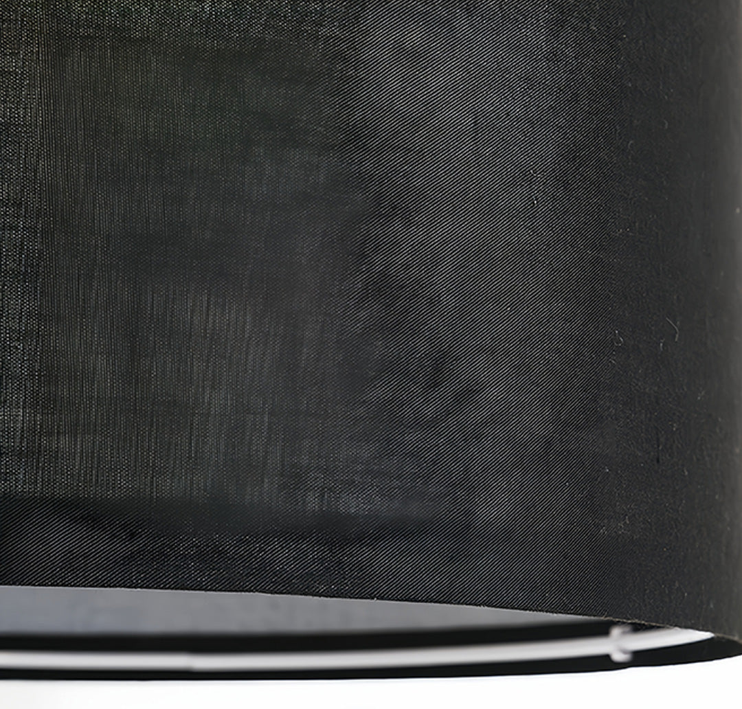 Close-up detail of small black pendant light showing woven fabric texture and premium construction