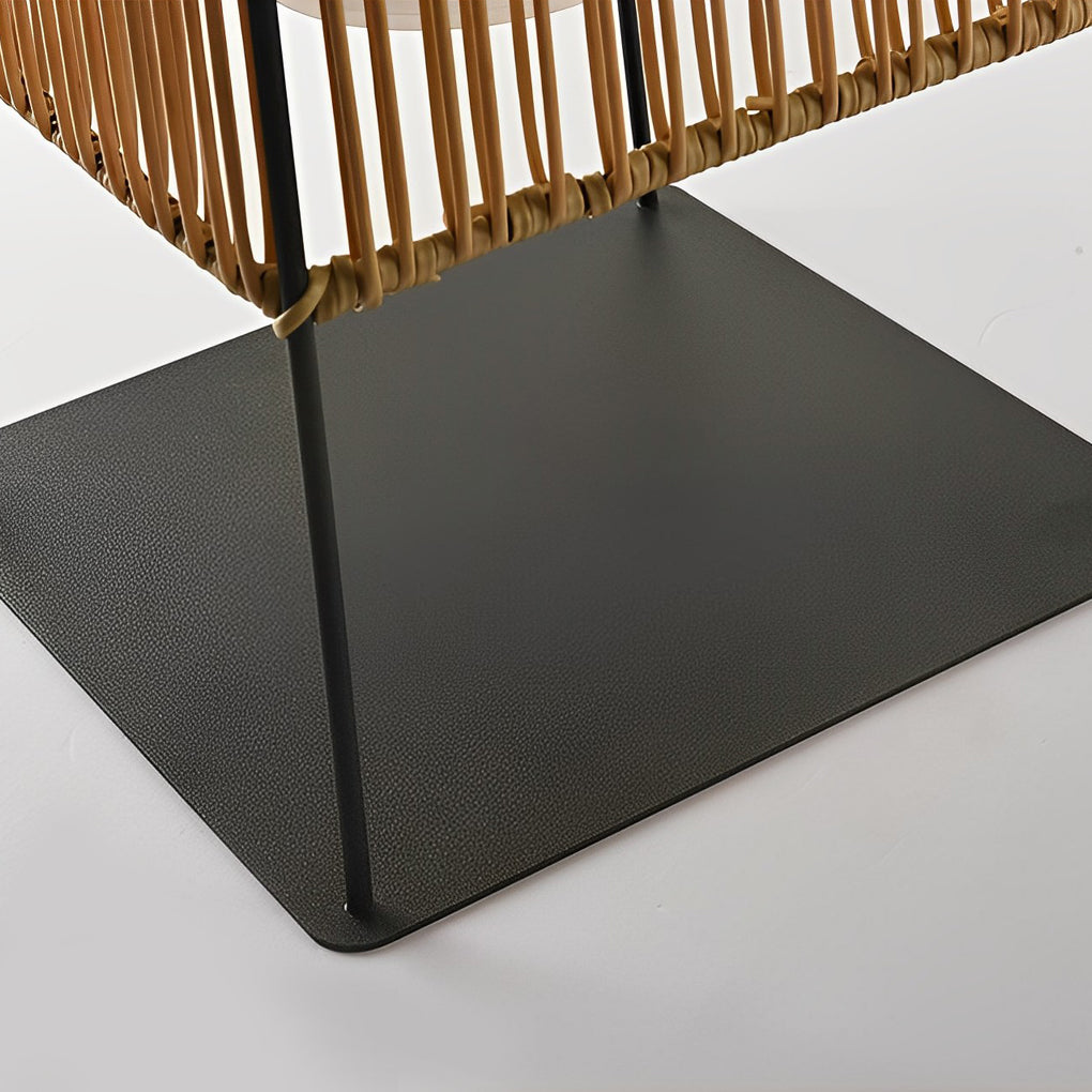 Woven floor lamp with a modern design, providing soft light in a garden setting.