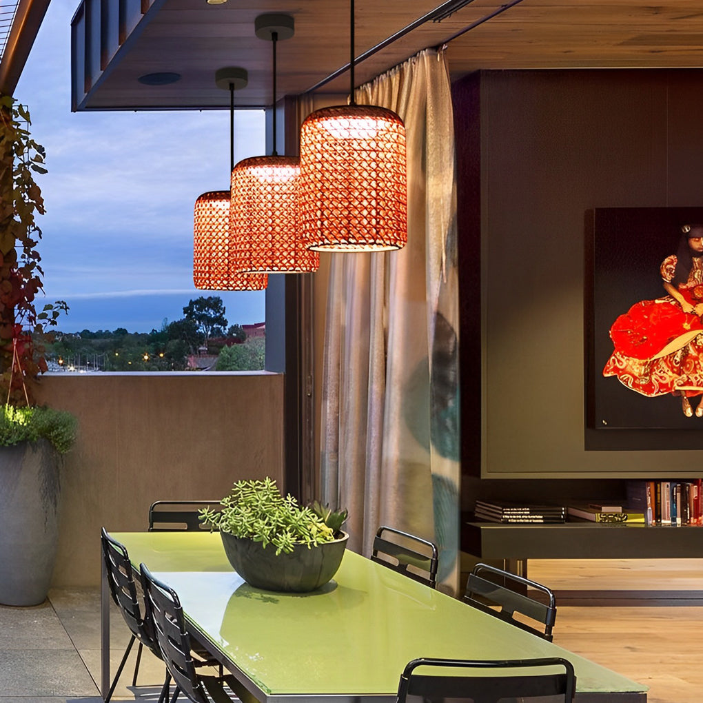 Woven hanging lantern with a red woven texture, providing ambient light under a tree.