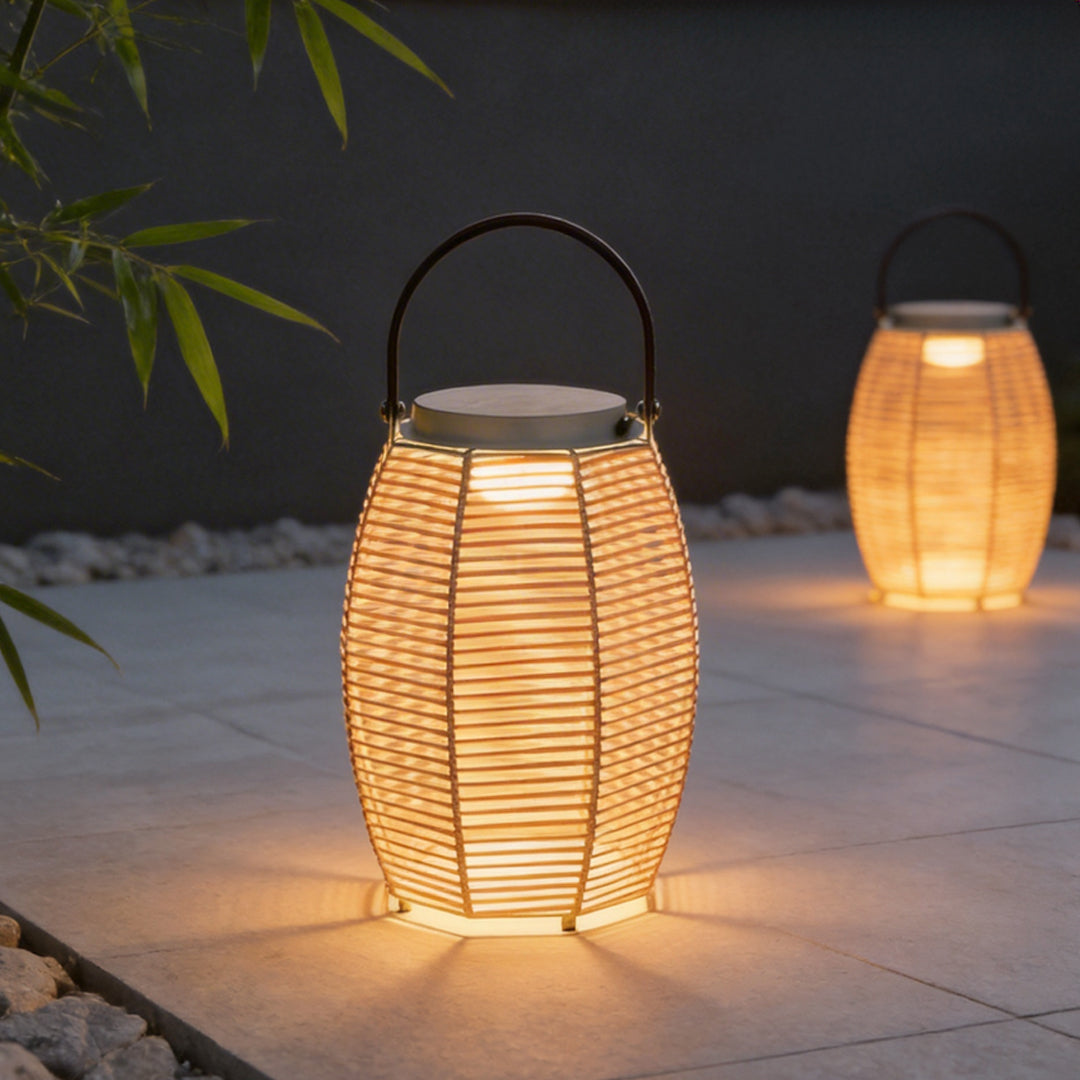 Woven rattan lanterns providing warm ambient lighting on a patio table at night.
