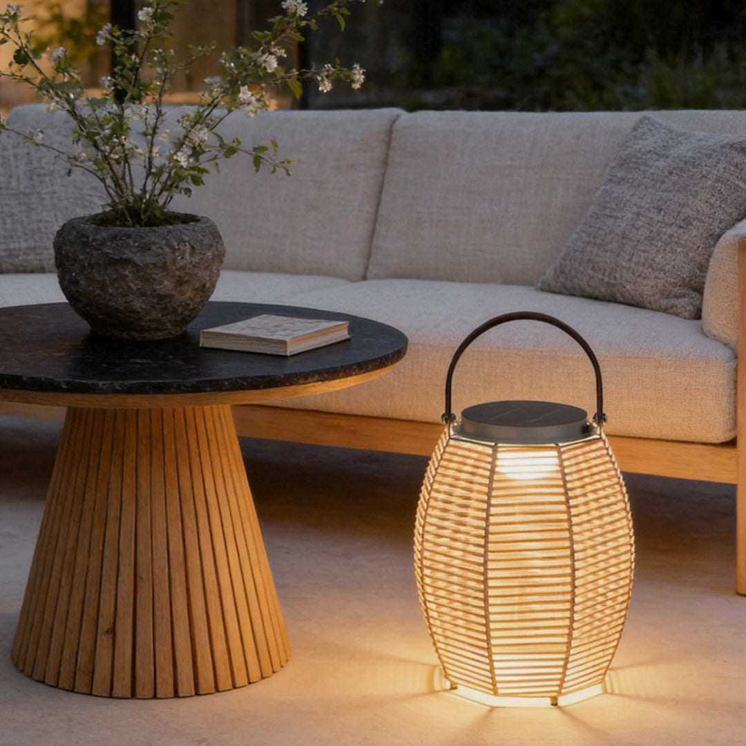 Woven rattan lanterns placed on a wooden table, creating a cozy outdoor setting.