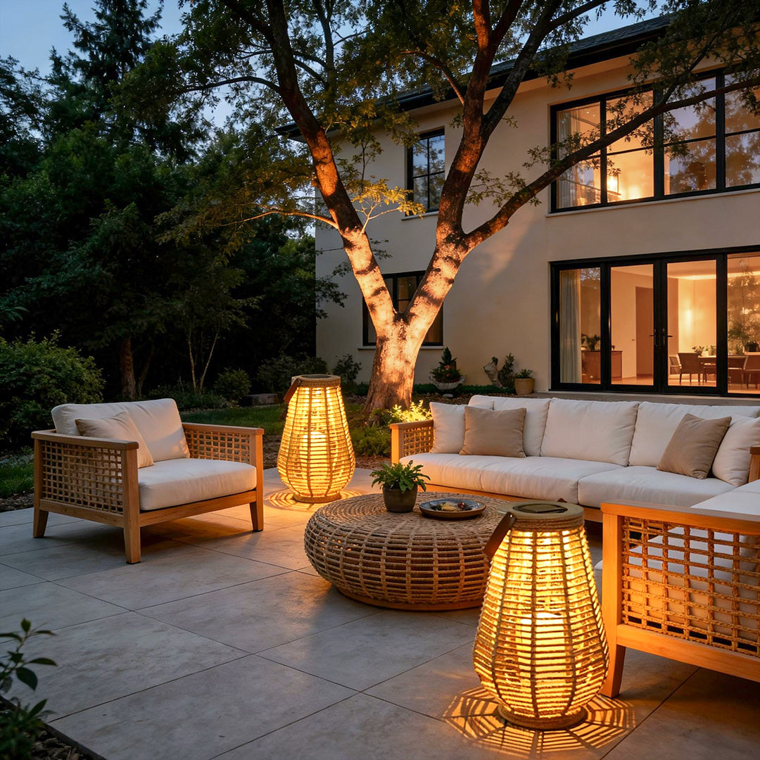 Woven rattan solar lantern decorating modern backyard seating area with soft lighting.