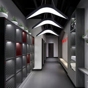 Spacious meeting room illuminated by a modern wrought iron chandelier, creating a stylish and professional atmosphere.