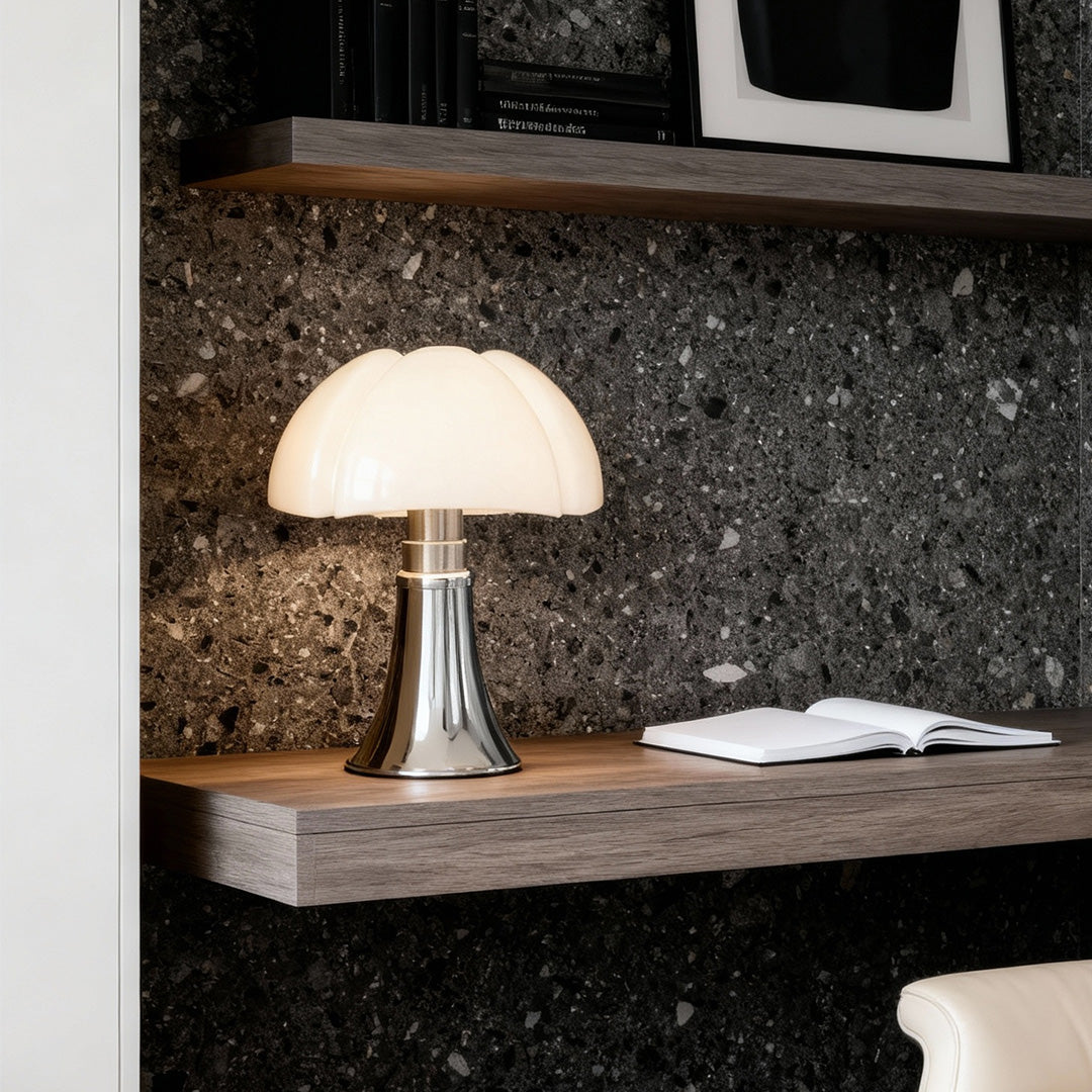 Yellow Bauhaus mushroom lamp with chrome base on shelf, minimalist room lighting.