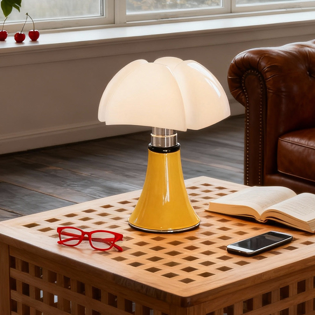 Yellow Bauhaus table lamp on patterned coffee table in modern living room.