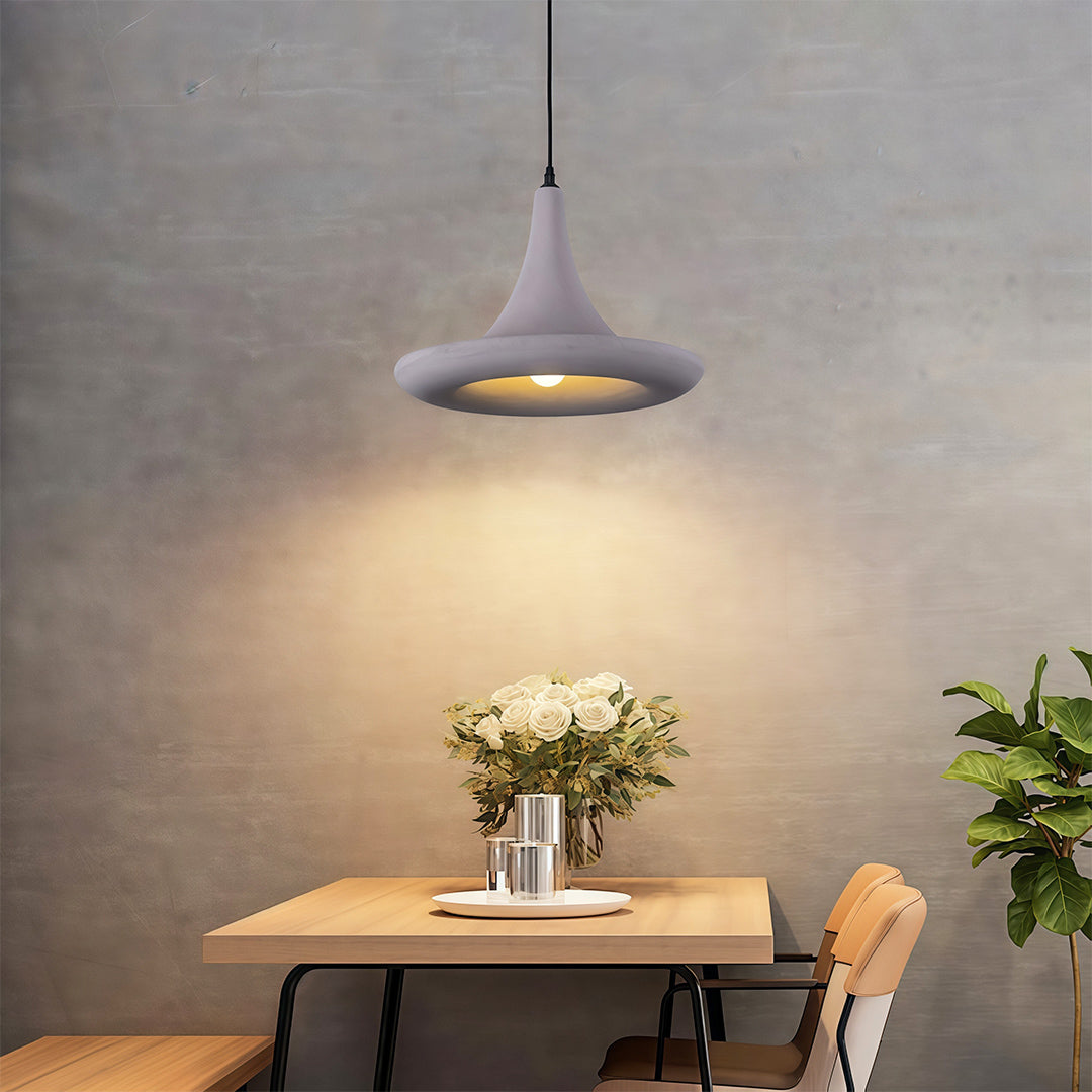 Zen-inspired Japanese pendant light fixtures featuring glass shade chandelier aesthetic with warm glow over natural wood dining table.