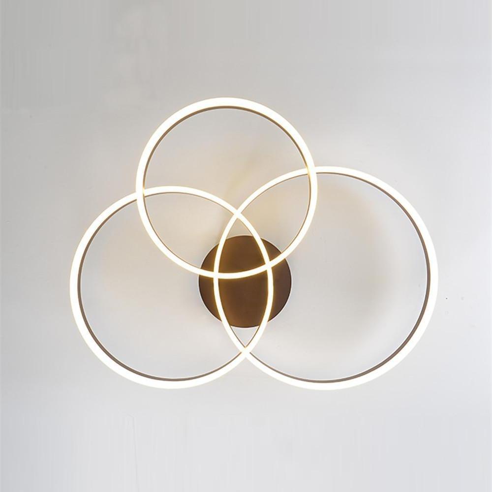 Elegant 3-ring flush mount ceiling light with artistic circular ring design on a white background.
