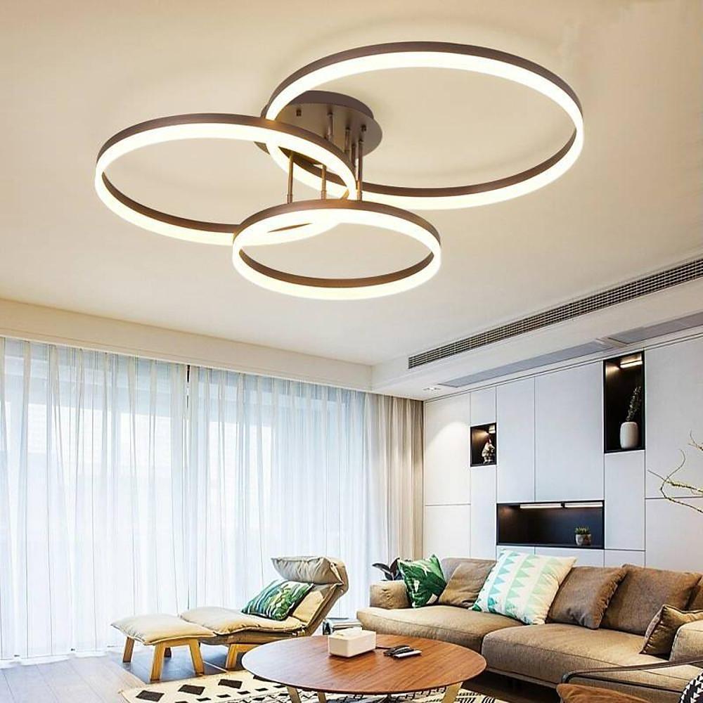 Minimalist 3-ring flush mount ceiling light providing soft ambient lighting in a bright living space.