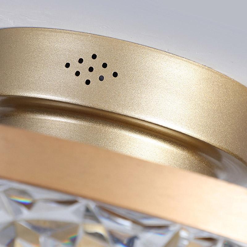 5-blade fan light metal housing detail with ventilation holes.