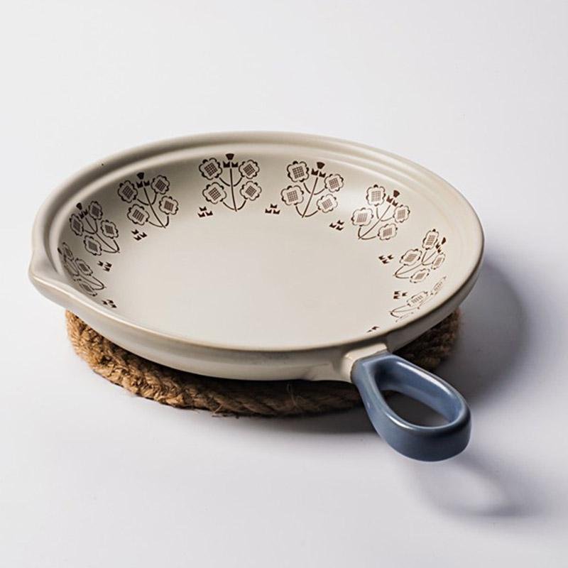 Beige Stoneware Plate With a Four Petal Flower Pattern Blue Handle