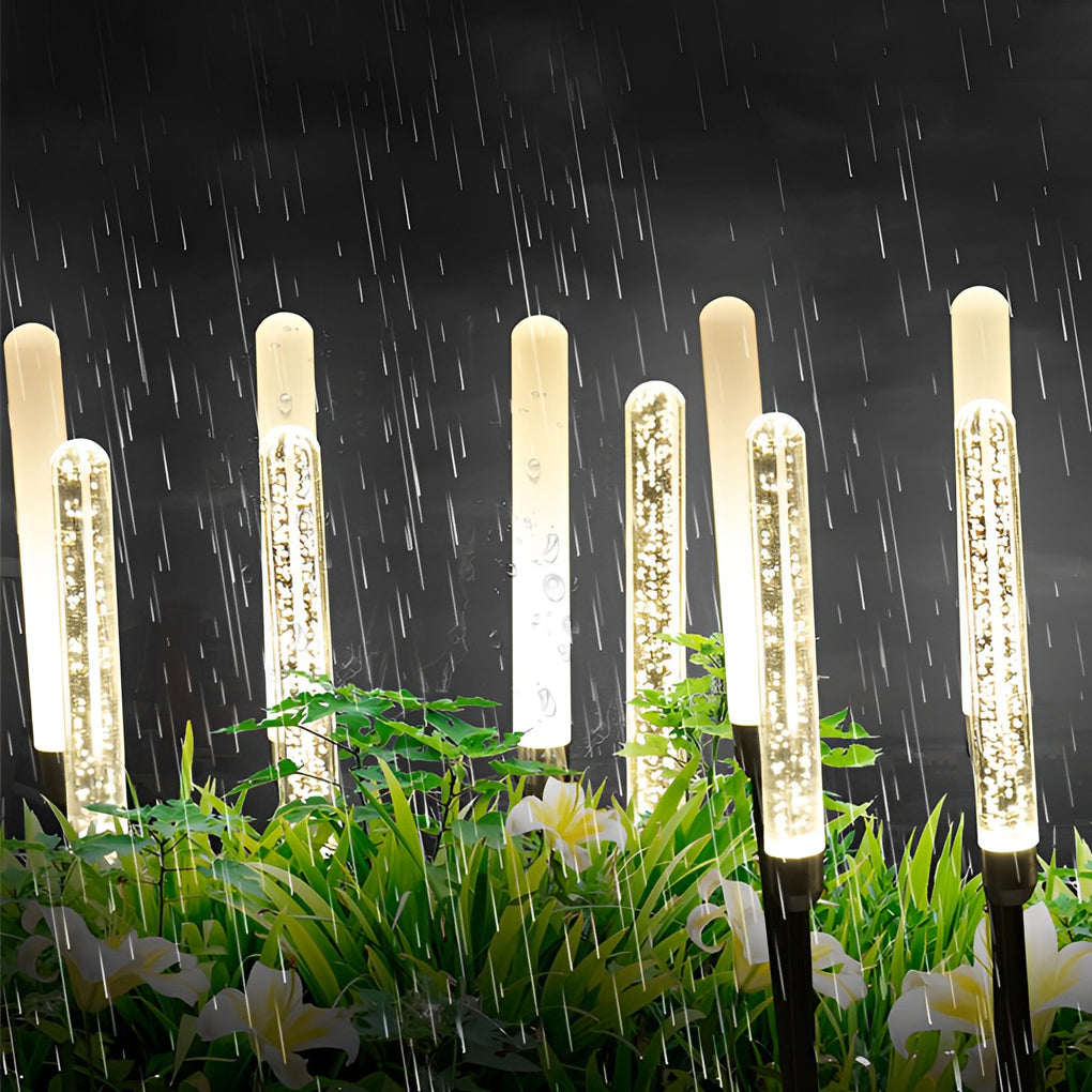 Acrylic bubble landscape light enhancing a modern outdoor setting with warm light.