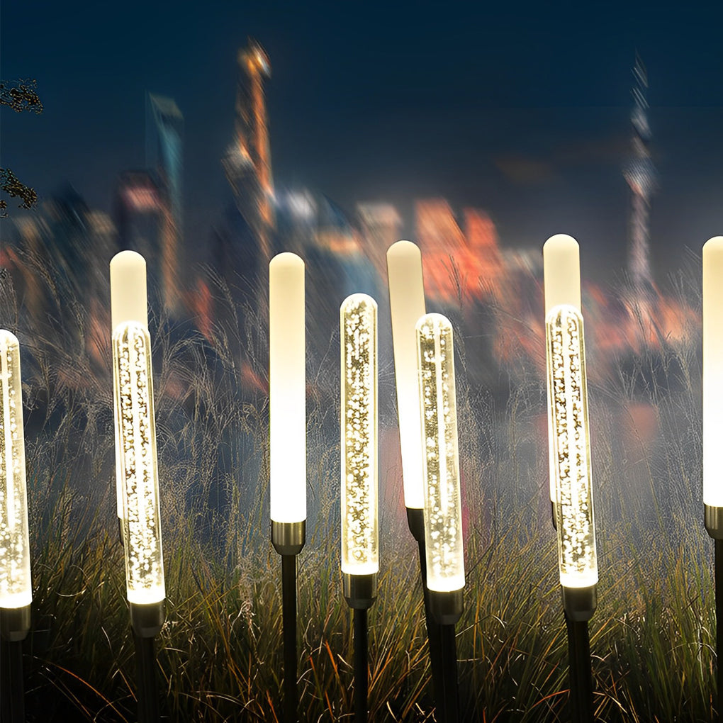 Acrylic bubble landscape light providing soft illumination along a stylish garden bed.