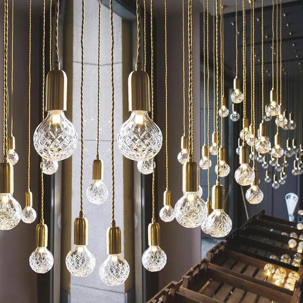Multiple acrylic bulb chandelier with cascading pendant design.