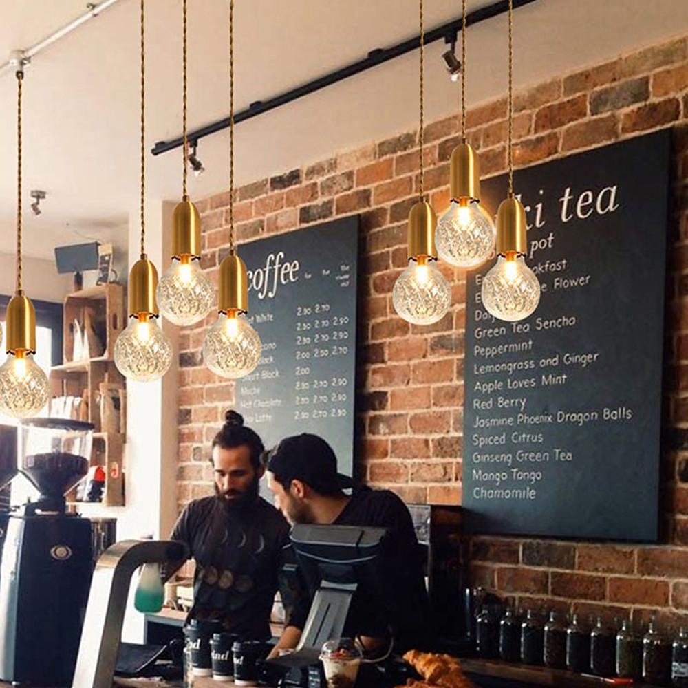 Modern acrylic bulb chandelier installed in coffee shop interior.