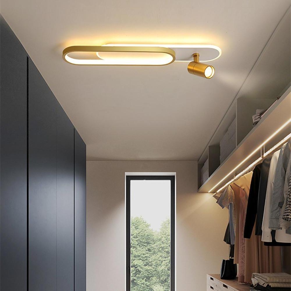 Adjustable ceiling spotlight lighting a corridor with warm LED accent glow.