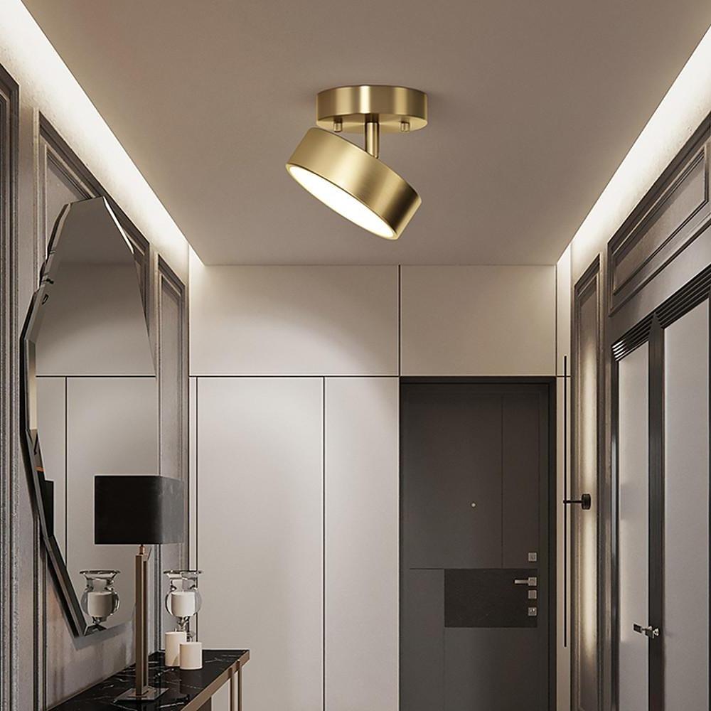 Adjustable LED ceiling light with angled head in a contemporary hallway design.