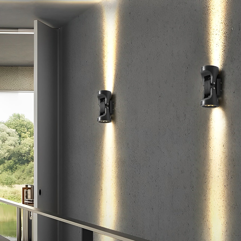 Adjustable outdoor wall light illuminating a minimalist exterior wall with focused glow.