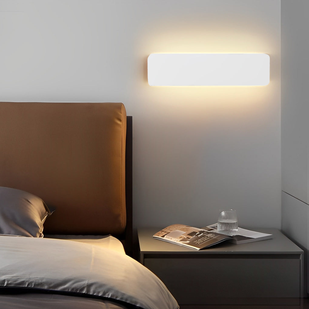 Adjustable wall light installed above sofa providing indirect illumination.