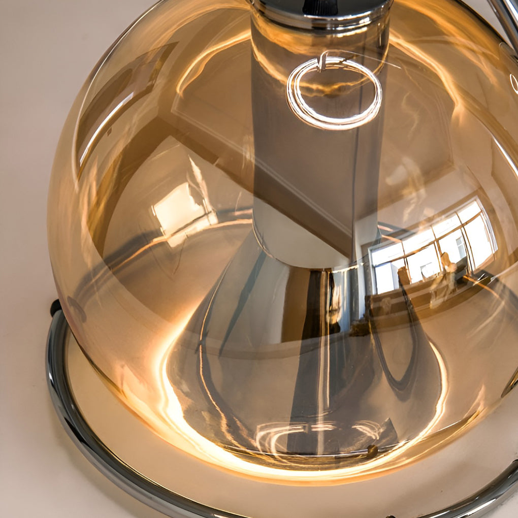 Amber glass globe pendant light interior close-up showing warm glow and reflective amber finish.
