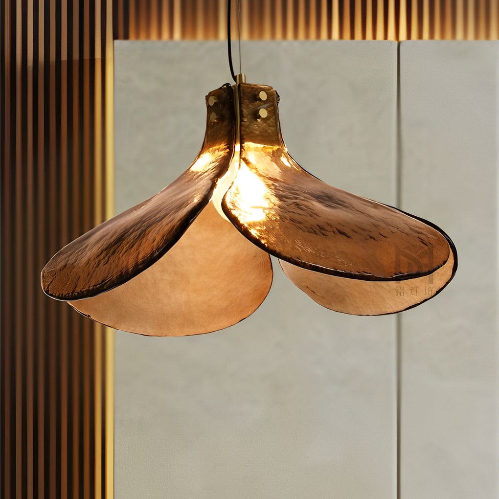 Amber glass pendant light illuminating a modern living room with artistic ambiance.
