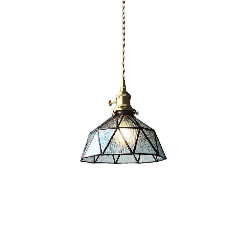 Amber indoor pendant light in brass, close-up of the detailed glass and metal.