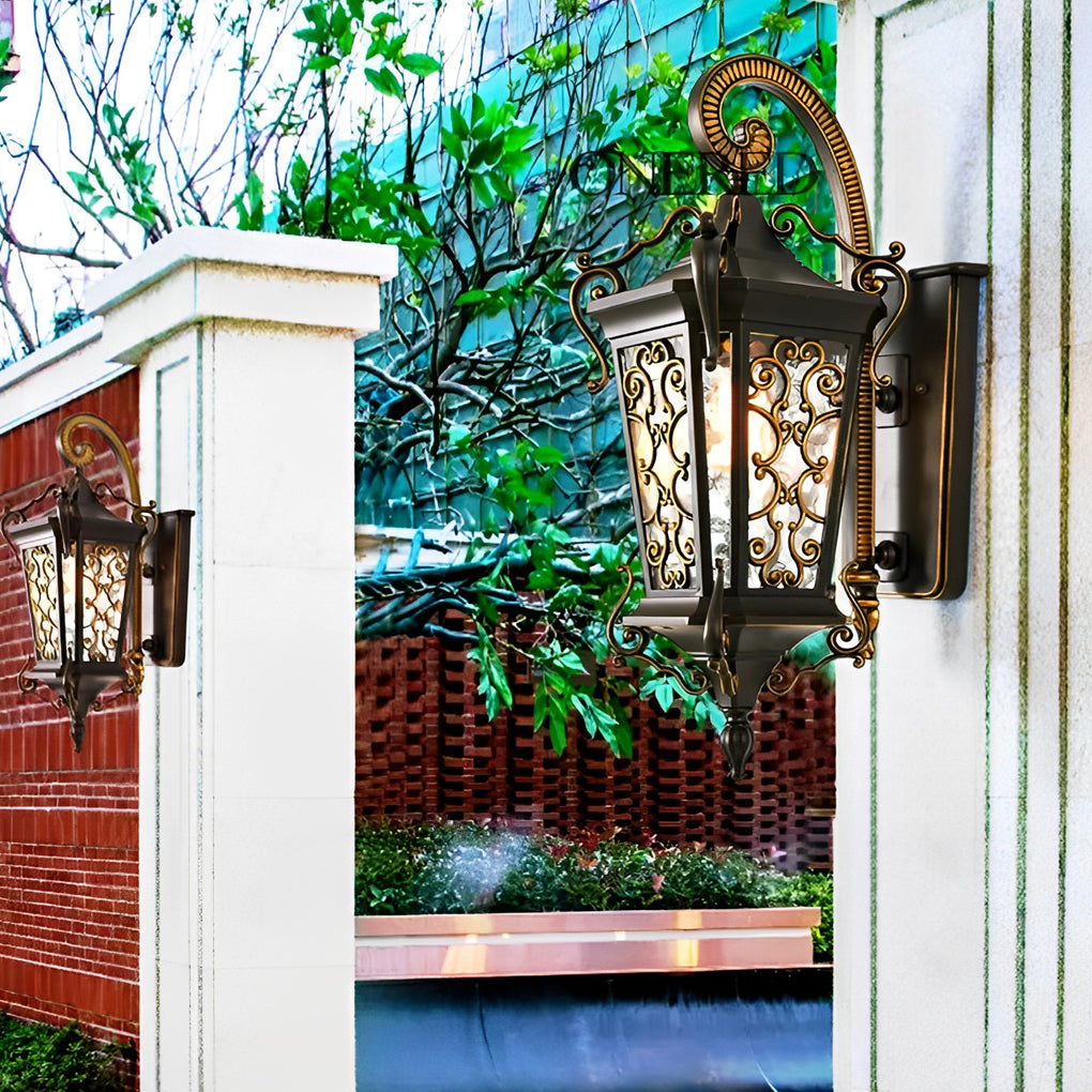 Close-up of antique outdoor wall sconce showing intricate metal scroll patterns and textured glass panels.