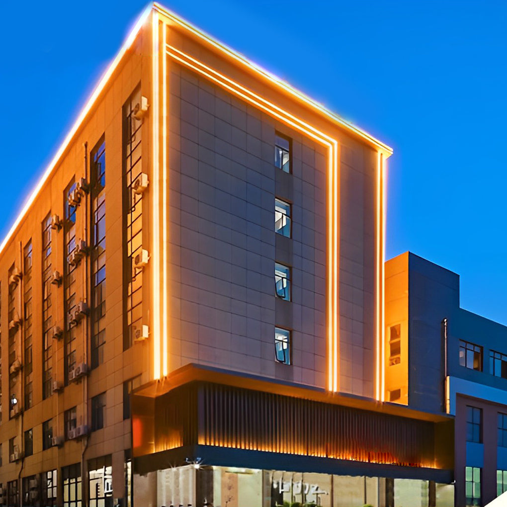 Architectural led strip lighting outlining a modern building facade with warm linear accents at night.