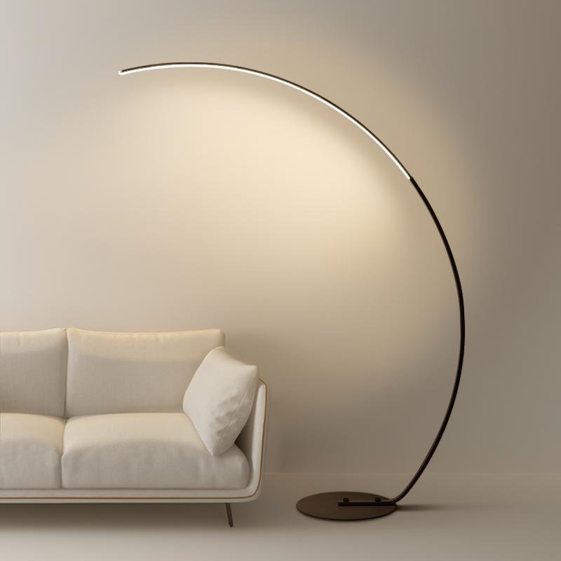 Arcing floor lamp with a modern curved design, providing soft illumination.