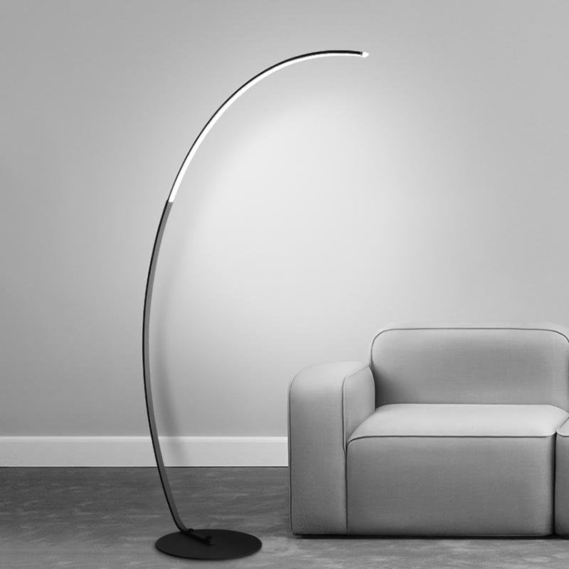 Arcing floor lamp with a modern design, enhancing the ambiance of a stylish living room.