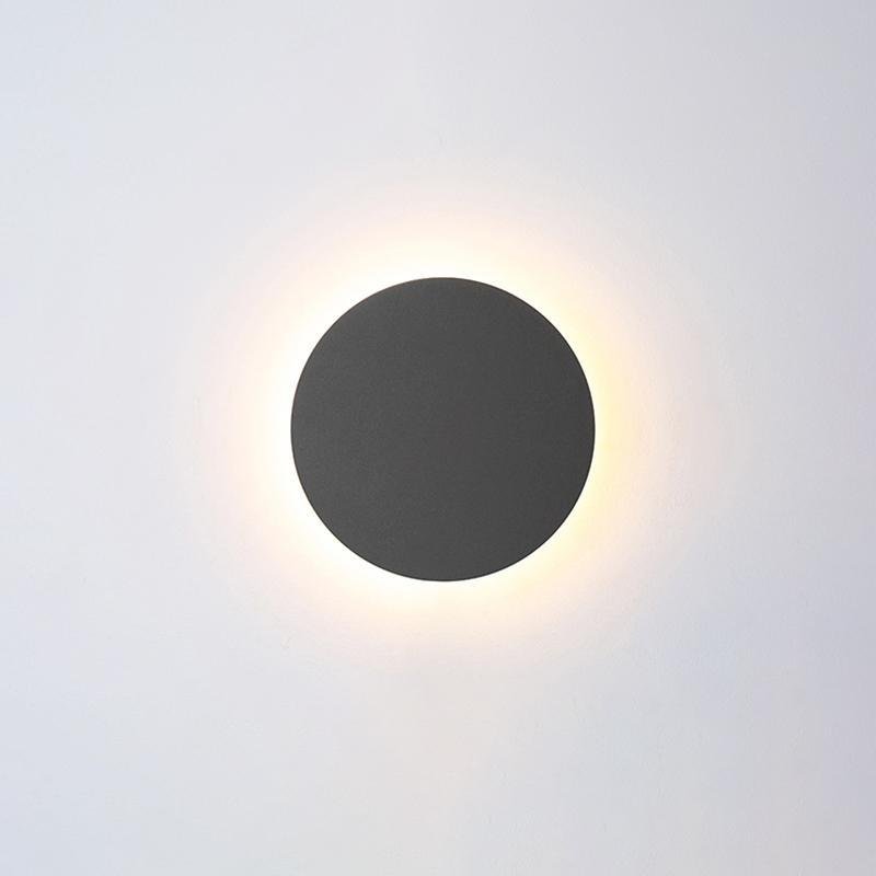 Black round backlit wall light with halo effect