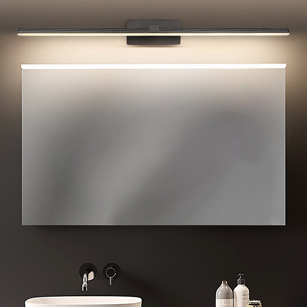 Dark-toned bathroom interior highlighted by linear bathroom lights above vanity mirror.