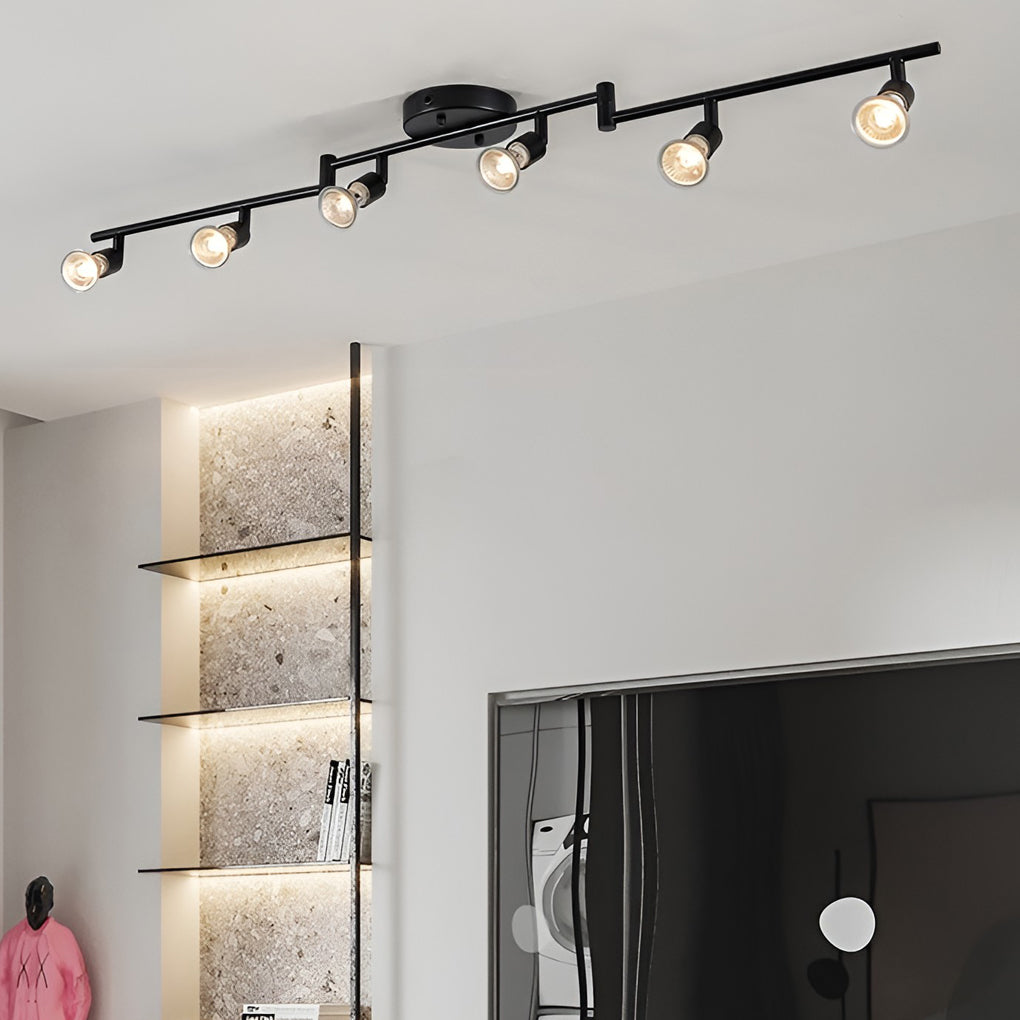 Black adjustable ceiling lights mounted along a hallway ceiling, delivering flexible directional lighting for passageways.