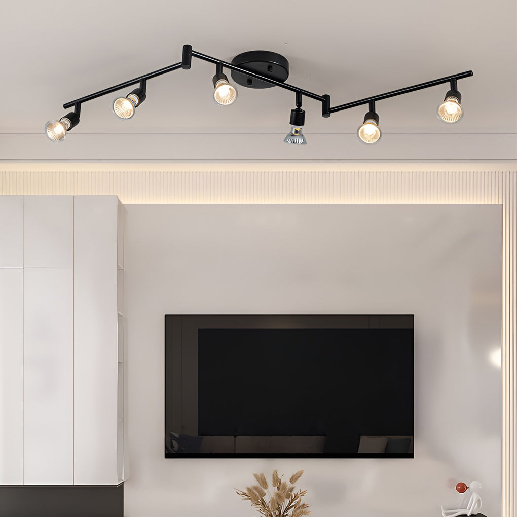 Black adjustable ceiling lights installed in a living room ceiling, creating even illumination with multiple pivot points.