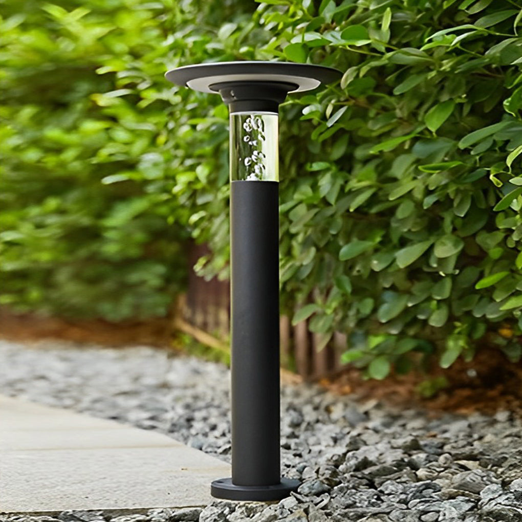 Black brass path lights with close-up of its sleek design and light output.