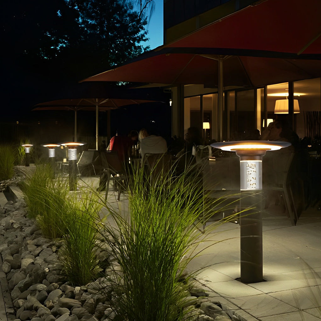 Black brass path lights illuminating a cozy outdoor deck with directional glow.