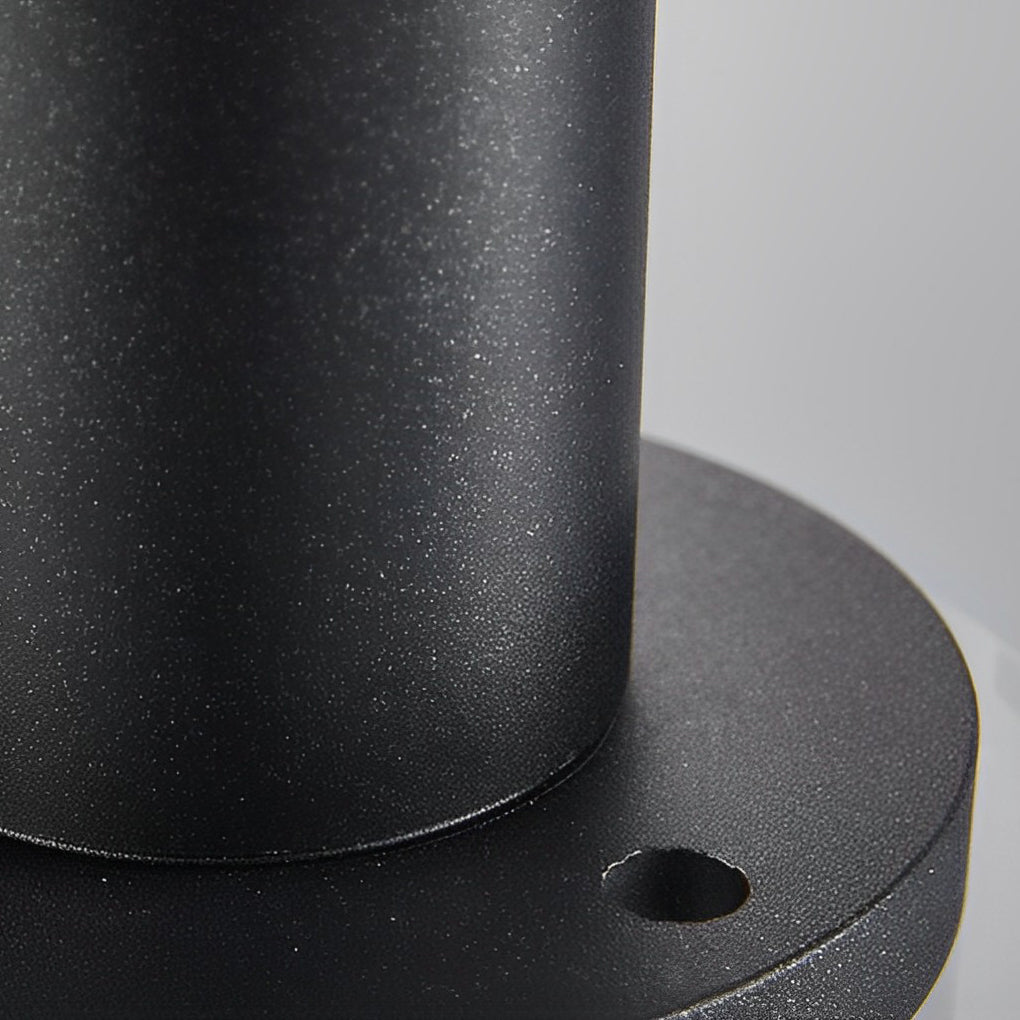 Black brass path lights with detailed view of its glass shade and structure.