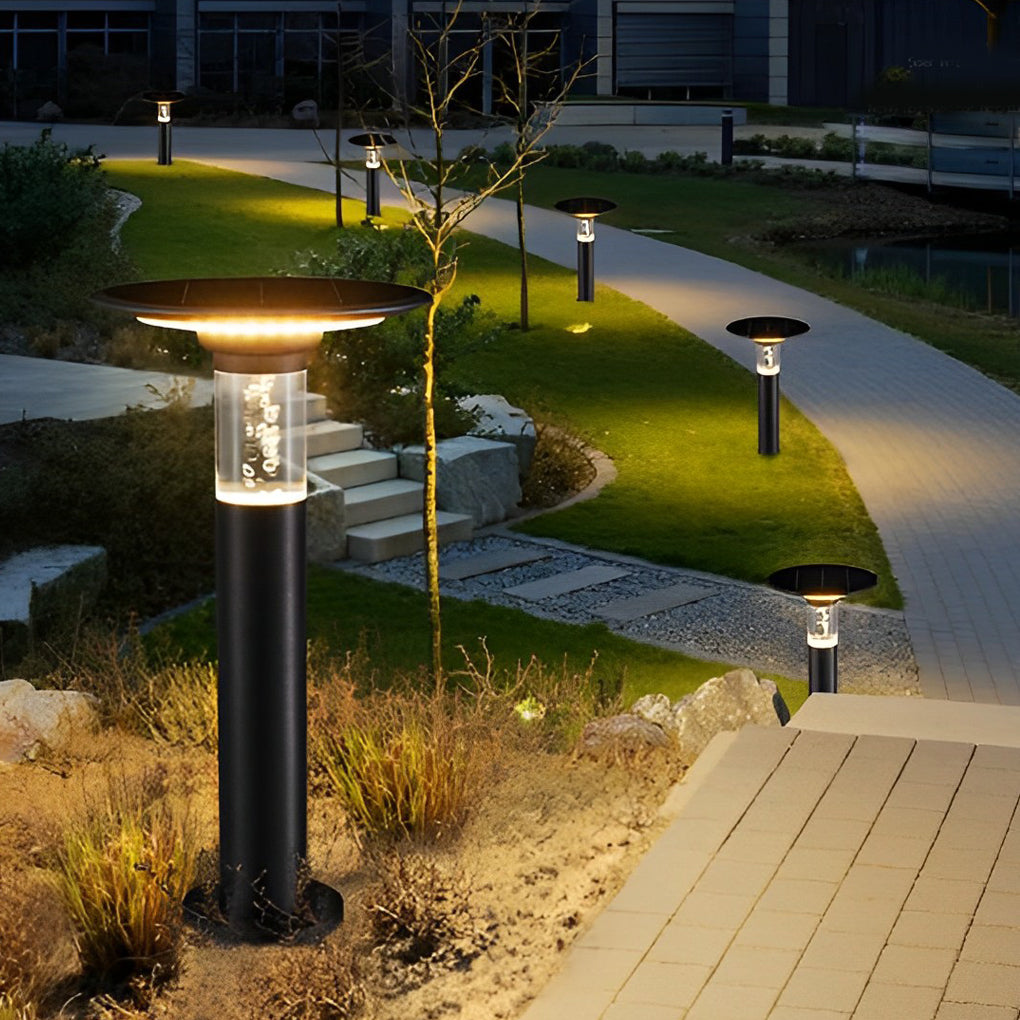 Black brass path lights enhancing a stylish outdoor entrance with ambient light.