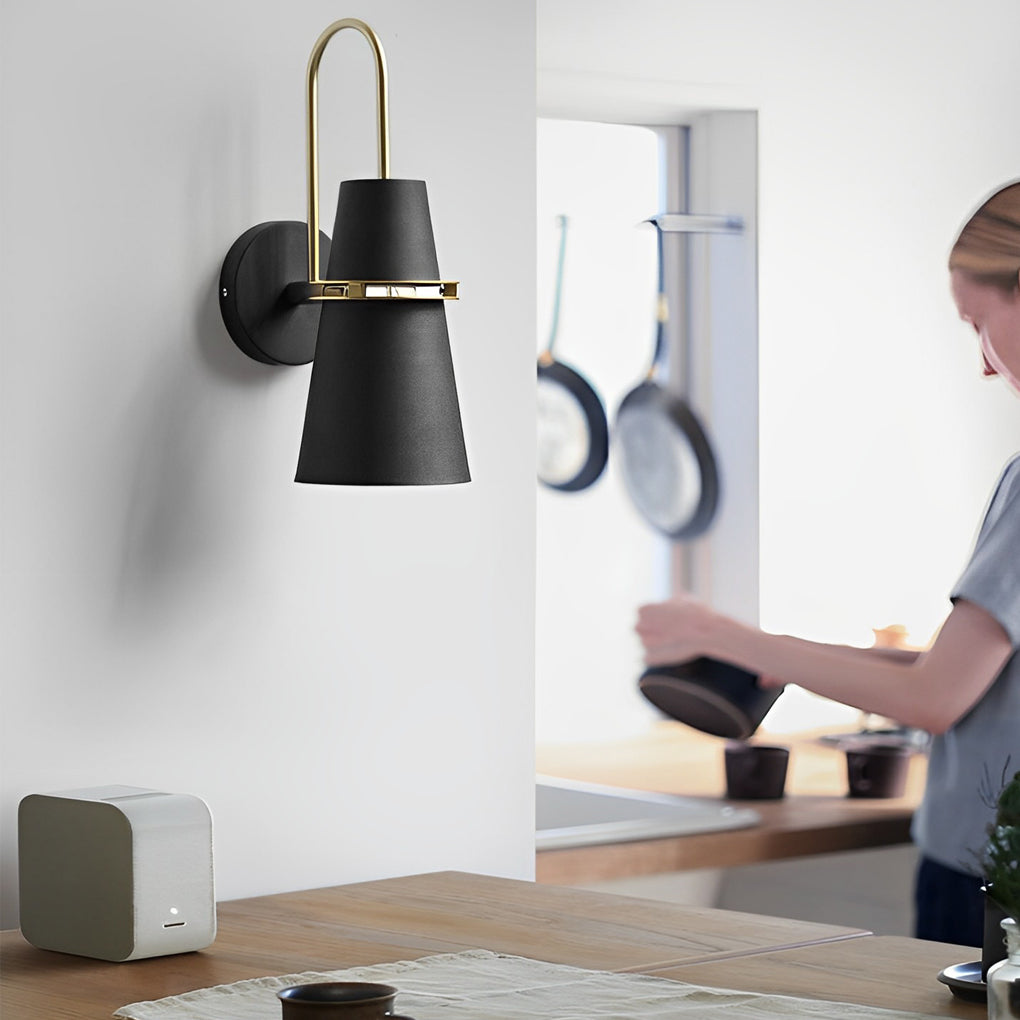 Black cone wall lamp used as task lighting above kitchen counter workspace.