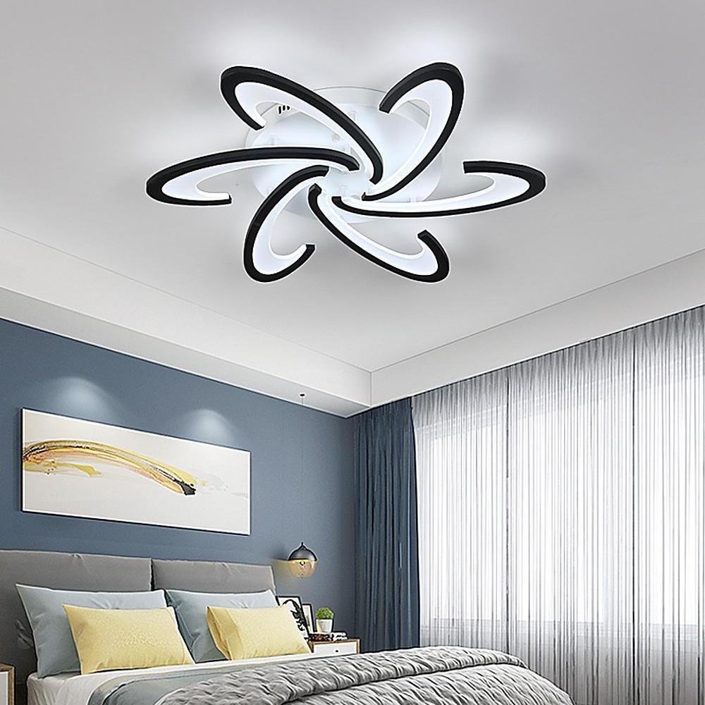 Black curved LED ceiling light in a modern bedroom with neutral decor.