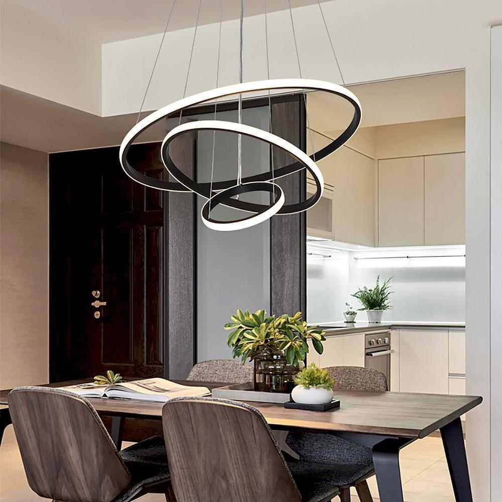 Black and gold ring LED chandelier in modern dining area.